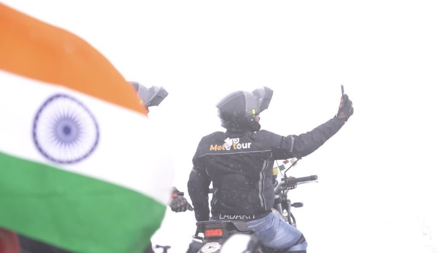 Rider celebrating in the snow on the Srinagar-Leh-Manali route