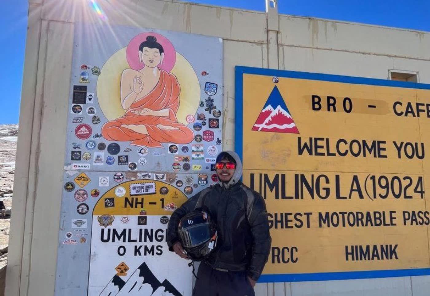 Rider at the Umling-La summit sign, the world's highest motorable pass